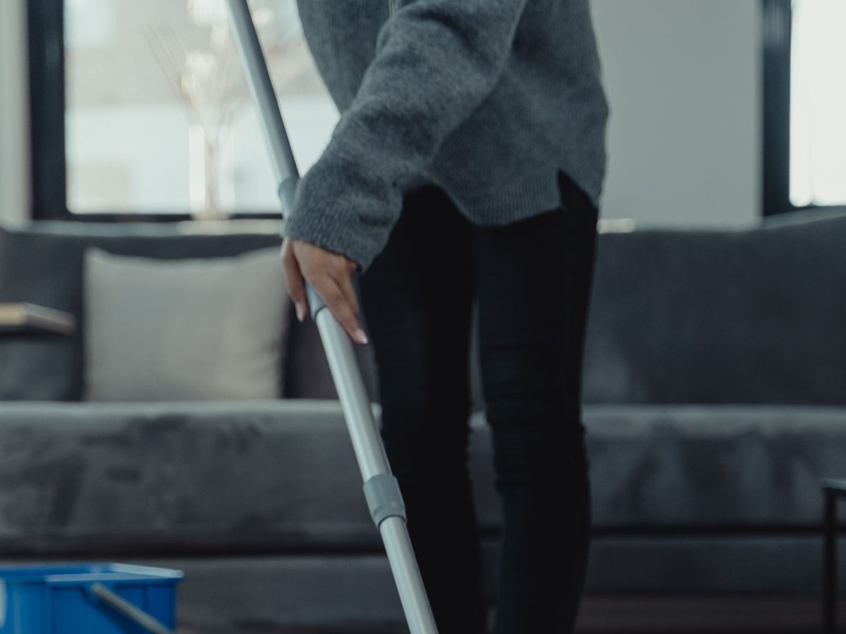 A professional cleaner mopping a floor, one of the trades Dam AI serves